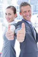 Two business colleagues giving thumbs up