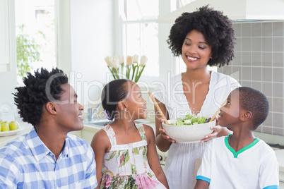 Happy family sitting down to dinner together