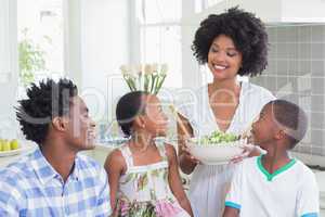 Happy family sitting down to dinner together