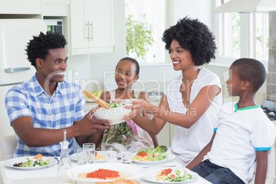 Happy family sitting down to dinner together