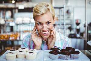 Pretty woman looking at cup cakes