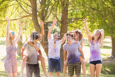 Young friends having fun with hose in the park