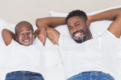 Father and son smiling at camera