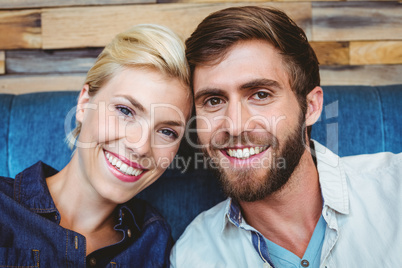 Cute couple on a date smiling at the camera