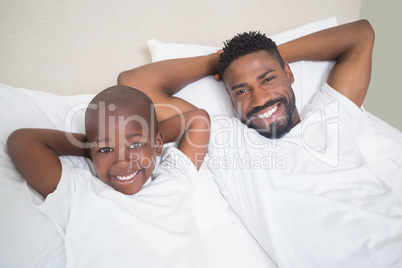 Father and son smiling at camera