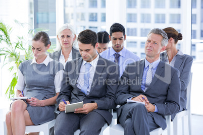 Business team taking notes during conference