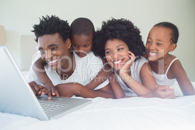 Happy family using the laptop together