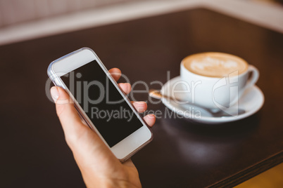 Hand of woman holding smartphone Hand of woman holding smartphone
