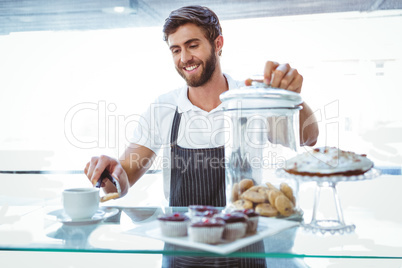 Smiling worker prepares breakfast