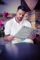 Young man reading a newspaper