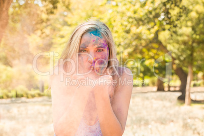 Young woman having fun with powder paint