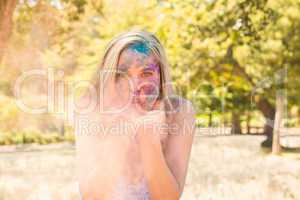 Young woman having fun with powder paint