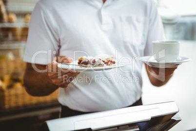 Smiling worker prepares breakfast