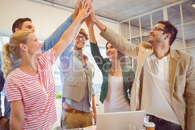 Happy business team doing hands checks