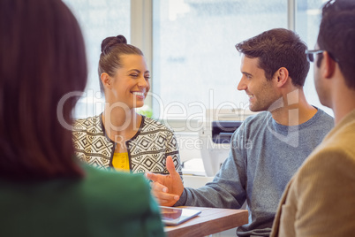 Smiling colleagues talking together