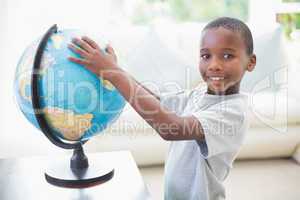 Little boy looking at the globe