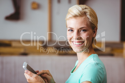 Pretty blonde woman using her smartphone