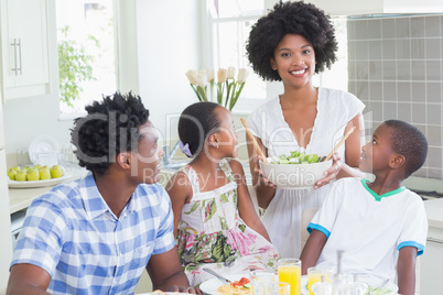 Happy family sitting down to dinner together