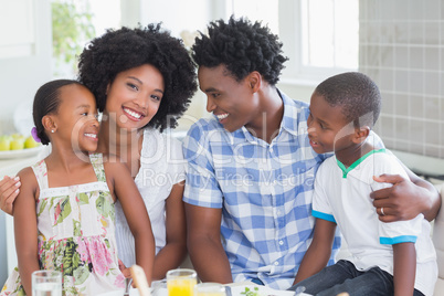 Happy family sitting down to dinner together