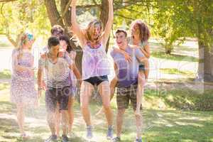 Young friends having fun with hose in the park