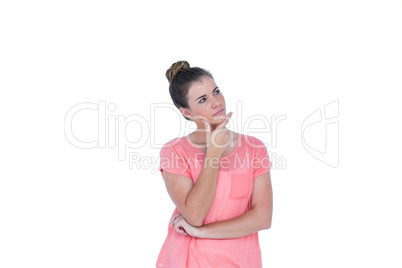 Thoughtful pretty casual brunette standing with hand on chin