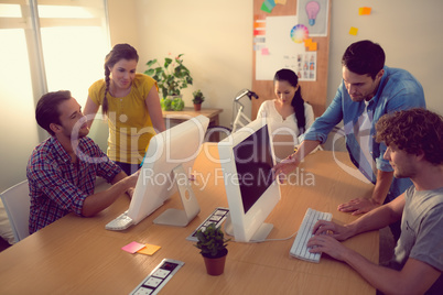 Attentive business team working on laptops