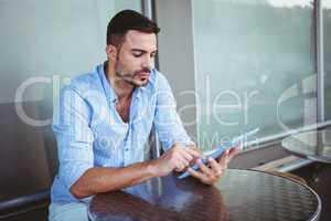 Attentive businessman using a tablet