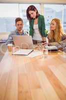 Group of young colleagues using laptop