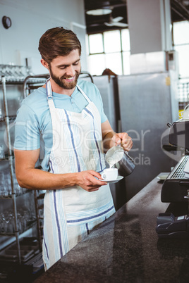 happy worker making coffee