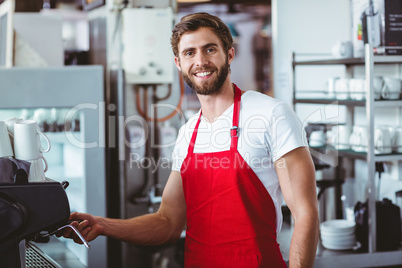 Handsome barista smiling at the camera