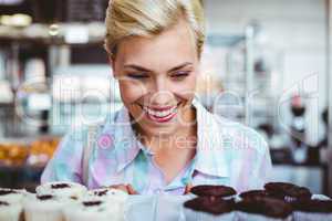 Pretty woman looking at cup cakes