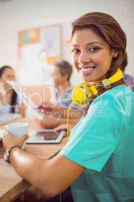 Smiling businesswoman with headphones in a meeting