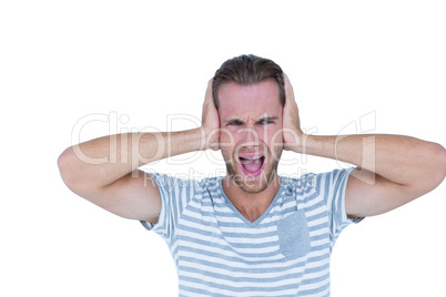 Handsome casual man screaming with hand on ears