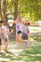 Young friends having fun with hose in the park