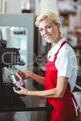 Pretty barista using the coffee machine