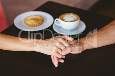 Cute couple on a date holding hands