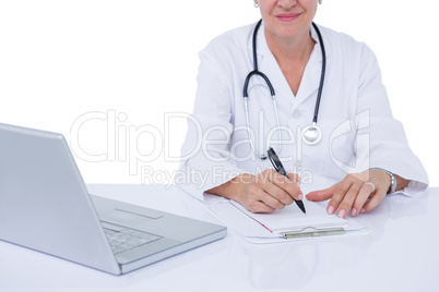 Doctor writing on a notepad