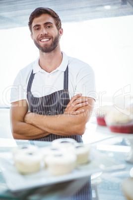 Smiling worker posing behind the counter