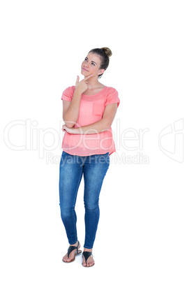 Thoughtful pretty casual brunette standing with hand on chin