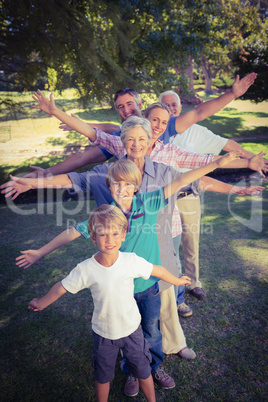 Happy family with arms outstretched in the park