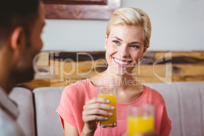 Pretty blonde holding a glass of orange juice