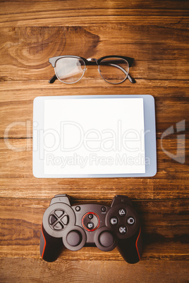 Tablet next to joystick and glasses