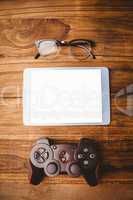 Tablet next to joystick and glasses
