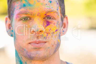 Young man having fun with powder paint