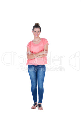 Happy pretty casual brunette looking at camera with arms crossed