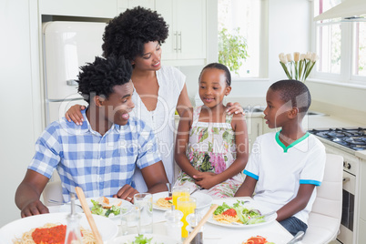 Happy family sitting down to dinner together