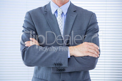 Smiling businessman with arms crossed