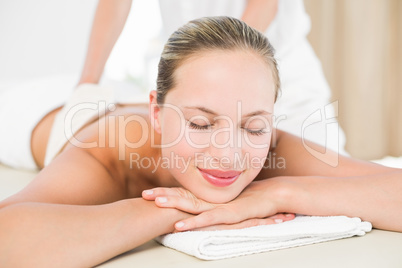 Peaceful blonde enjoying an exfoliating back massage