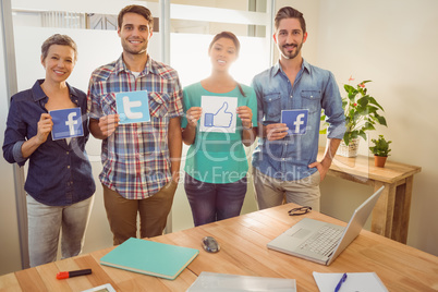 Colleagues holding sign from famous social networks