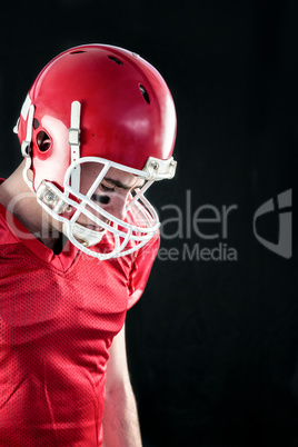 Amercian football player having his helmet on her head